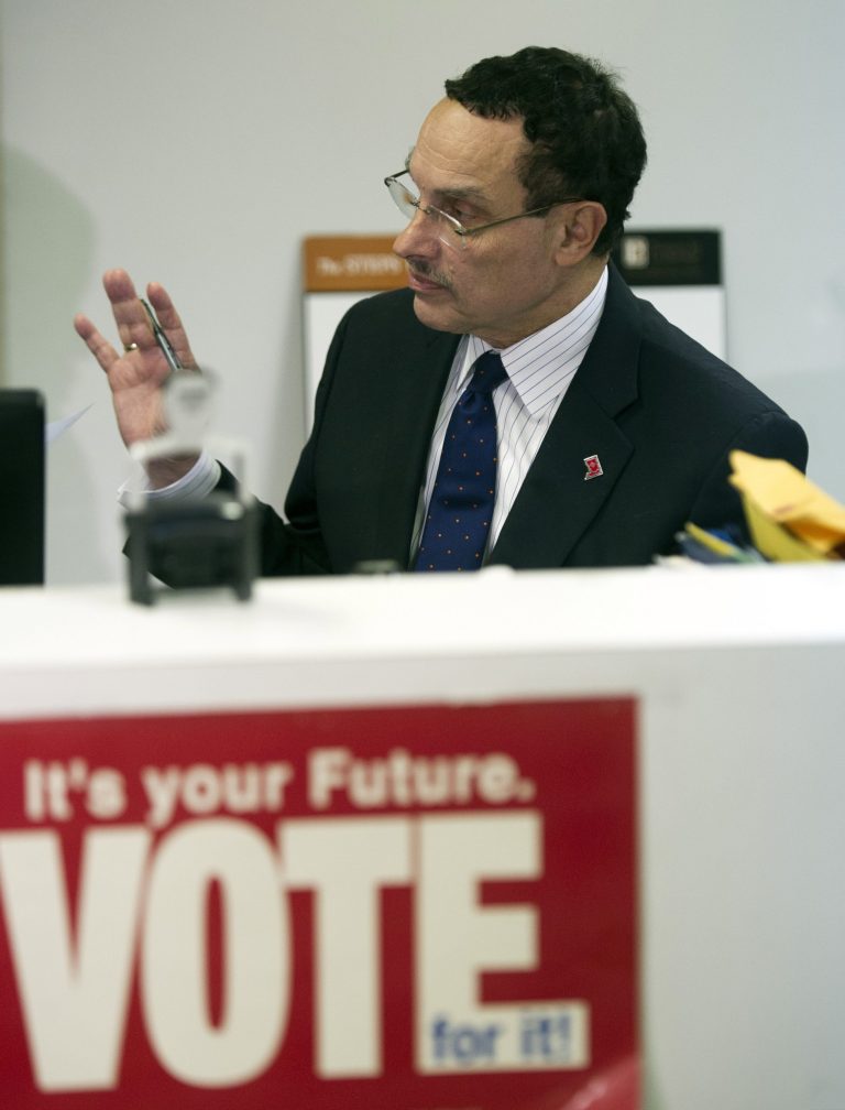 Washington Mayor Vincent Gray raises his right hand while swearing an oath as he files paperwork to run for a second term at Board of Elections in Washington, Monday, Dec. 2, 2013. Gray's decision sets up a campaign that will force voters to weigh the prosperity achieved during the Democrat's nearly three years in office against the crimes several close associates committed to help get him elected in 2010.(AP Photo/Cliff Owen)