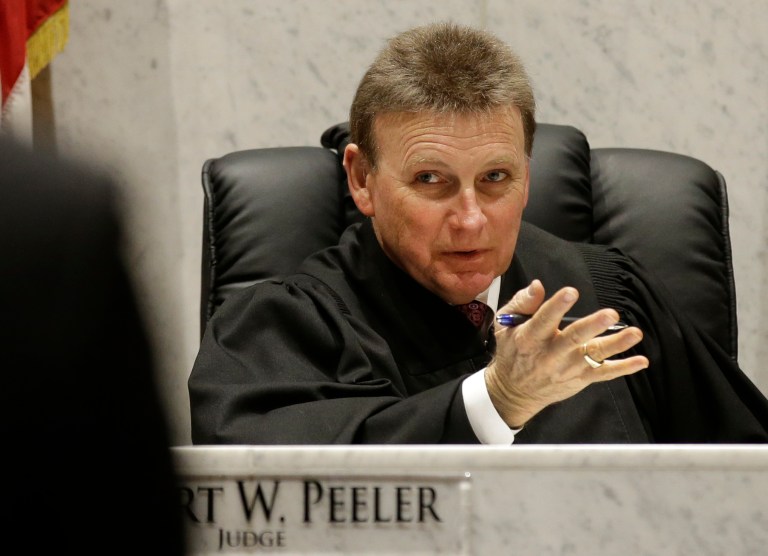 Judge Robert Peeler tries a case involving heroin abuse in Warren County Common Pleas Court, Tuesday, April 15, 2014, in Lebanon, Ohio. Peeler is among a growing number of judges and corrections officials across the country trying to combat the fast-growing national heroin problem by fighting heroin needles with treatment needles. Peeler sometimes orders monthly injections of the opiate-blocking drug Vivitrol to heroin users if they are willing. (AP Photo/Al Behrman)