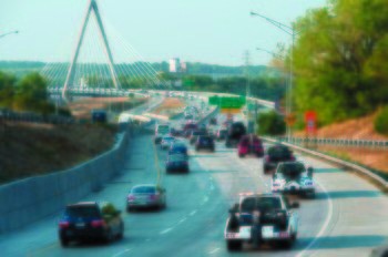 Tow trucks, like these driving over the Christopher S. Bond Bridge in Kansas City, could be busy when E15 gas becomes more available. (AP Photo/The Kansas City Star, David Eulitt )