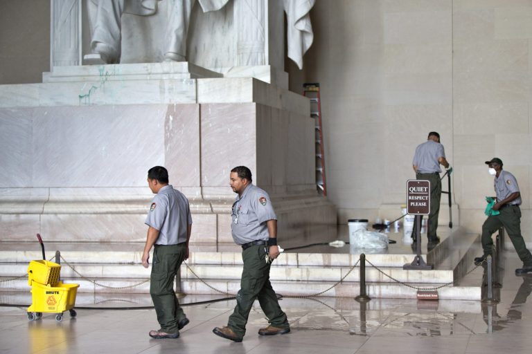   FILE - This July 26, 2013 file photo shows National Park Service workers cleaning the Lincoln Memorial in Washington, after someone splattered green paint on the statue of the 16th president and the floor area. National Park Service officials say three areas of the Lincoln Memorial statue still show faint signs of green staining after a vandal splattered green paint at the site last week. (AP Photo/J. Scott Applewhite, File)  