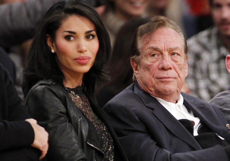 FILE - In this Dec. 19, 2010, file photo, Los Angeles Clippers owner Donald Sterling, right, and V. Stiviano, left, watch the Clippers play the Los Angeles Lakers during an NBA preseason basketball game in Los Angeles. NBA Commissioner Adam Silver is intent on moving quickly in dealing with the racially charged scandal surrounding Clippers owner Sterling. The NBA league will discuss its investigation Tuesday, April 29, 2014, before the Clippers play Golden State in Game 5 of their playoff series. (AP Photo/Danny Moloshok, File)