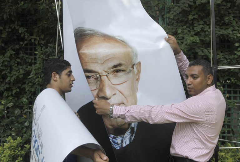   Egyptian workers uninstall a billboard showing presidential candidate Ahmed Shafiq, at his campaign headquarters office following a press conference in Cairo, Egypt, Monday, June 18, 2012. The Muslim Brotherhood declared early Monday that its candidate, Mohammed Morsi, won Egypt's presidential election, which would be the first victory of an Islamist as head of state in the stunning wave of protests demanding democracy that swept the Middle East the past year. (AP Photo/Amr Nabil)  