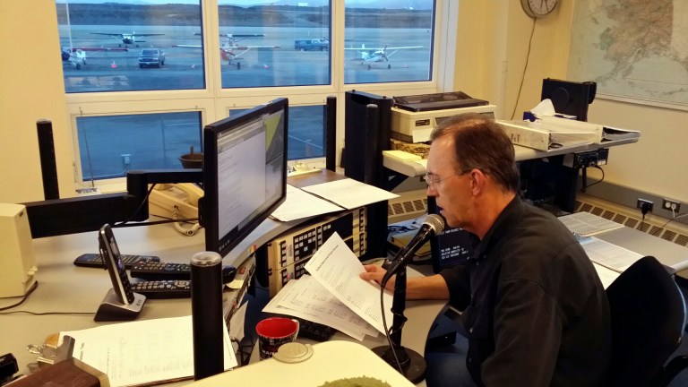 In this June 9, 2014 photo, National Weather Service meteorological technician Robert Murders reads the weather at the weather service office in Nome, Alaska. The Nome and Kodiak offices are among the last two in the nation to still use human voices for weather forecasts, but that will soon change. Both officers are switching to computerized voices that nationally go by the names of Tom, Donna and, in some parts of the country, Spanish-speaking Javier. It's an idea first hatched in the mid-1990s as part of a move to modernize the weather service, an agency of the National Oceanic and Atmospheric Administration. (AP Photo/KNOM, Rolland Trowbridge)