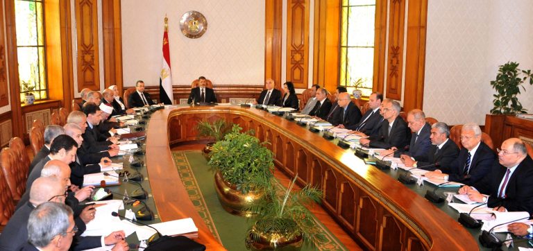 In this image released by the Egyptian Presidency, Mohammed Morsi, center, meets with his cabinet in Cairo, Egypt, Tuesday, May 7, 2013. Nine new Egyptian ministers joined President Mohammed Morsi's Cabinet on Tuesday, including two members of his Muslim Brotherhood, in a reshuffle that officials said was aimed at addressing the country's financial woes and securing a much-needed international loan. (AP Photo/Egyptian Presidency)