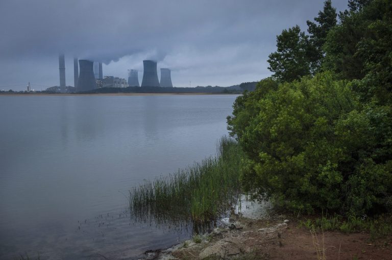 The coal-fired Plant Scherer is shown in operation early Sunday, June 1, 2014, in Juliette, Ga. The Obama administration unveiled a plan Monday to cut carbon dioxide emissions from power plants by nearly a third over the next 15 years, in a sweeping initiative to curb pollutants blamed for global warming. (AP Photo/John Amis)