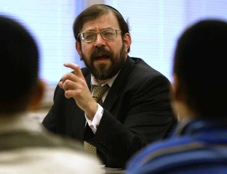 In a Jan. 7, 2003 photo, Rabbi S. Binyomin Ginsberg leads students at the Torah Academy in St. Louis Park, Minn., in a discussion and debate. The Supreme Court indicated Tuesday, Dec. 3, 2013 it won't offer much help to frequent flyers who want to sue when airlines revoke their miles or their memberships. The justices heard the case of Ginsberg, who was stripped of his top-level 