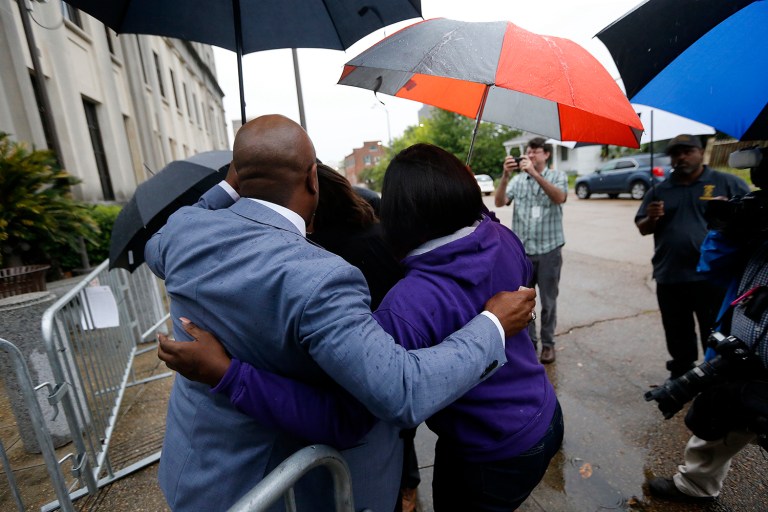 Chris Stewart, left, attorney for Alton Sterling's son Cameron Sterling and his mother Quinyetta McMillan, hugs family members of Alton Sterling as they arrive at federal court in Baton Rouge, La., Wednesday, May 3, 2017, to meet with the U.S. Justice Department officials. (AP Photo/Gerald Herbert)