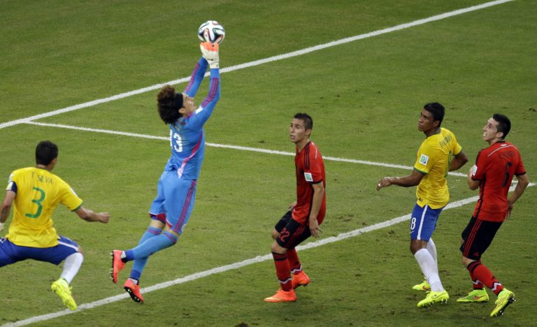 Mexico's goalkeeper Guillermo Ochoa makes a save during the group A World Cup soccer match between Brazil and Mexico at the Arena Castelao in Fortaleza, Brazil, Tuesday, June 17, 2014.  (AP Photo/Themba Hadebe)