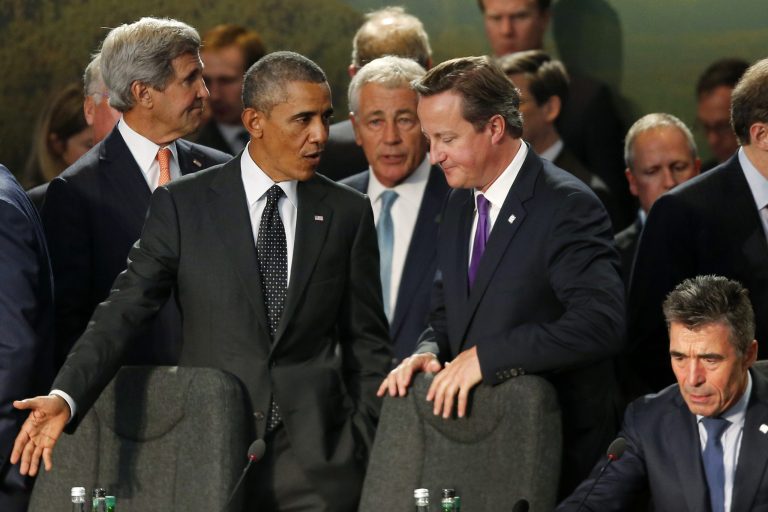 President Barack Obama speaks with British Prime Minister David Cameron as NATO leaders meet regarding Afghanistan at the NATO summit at Celtic Manor in Newport, Wales, Thursday, Sept. 4, 2014. From left are, Secretary of State John Kerry, the president, Defense Secretary Chuck Hagel and NATO Secretary-General Anders Fogh Rasmussen. (AP Photo/Charles Dharapak)
