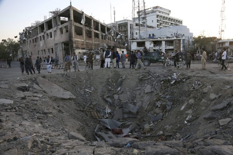 A suicide bomber rocked Kabul's diplomatic neighborhood Wednesday by detonating a truckload of explosives, creating a blast that shattered windows about a mile away from the site. (AP Photo/Rahmat Gul)