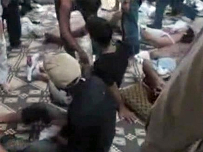   This citizen journalism image made from video provided by Shaam News Network SNN, purports to show two injured Syrian boys who survived a massacre in Mazraat al-Qubair on the outskirts of Hama, central Syria, Thursday, June 7, 2012. Syria on Thursday denied as 