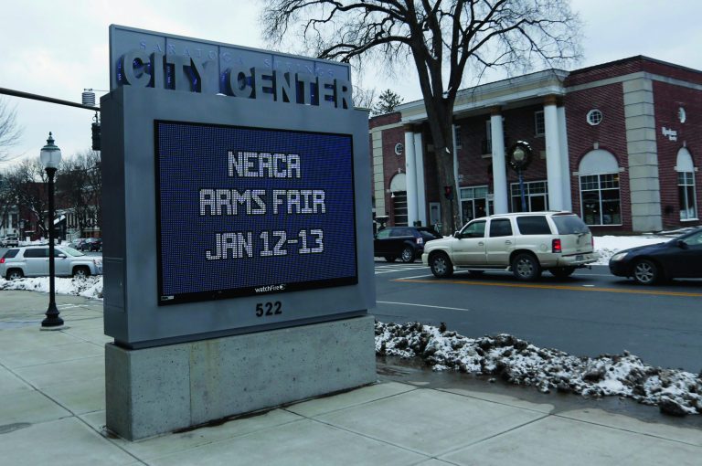 A sign at the Saratoga Springs City Center advertises an upcoming arms fair on Friday, Jan. 4, 2013, in Saratoga Springs, N.Y. (AP Photo/Mike Groll)