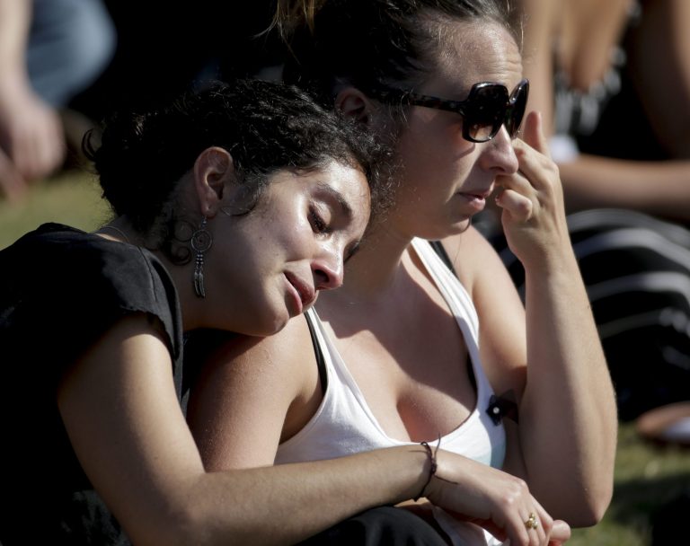 Students cry during a memorial service for the victims and families of Friday's rampage at Harder Stadium on the campus of University of California, Santa Barbara on Tuesday, May 27, 2014 in the Isla Vista area near Goleta, Calif.ÃÂ (AP Photo/Chris Carlson)