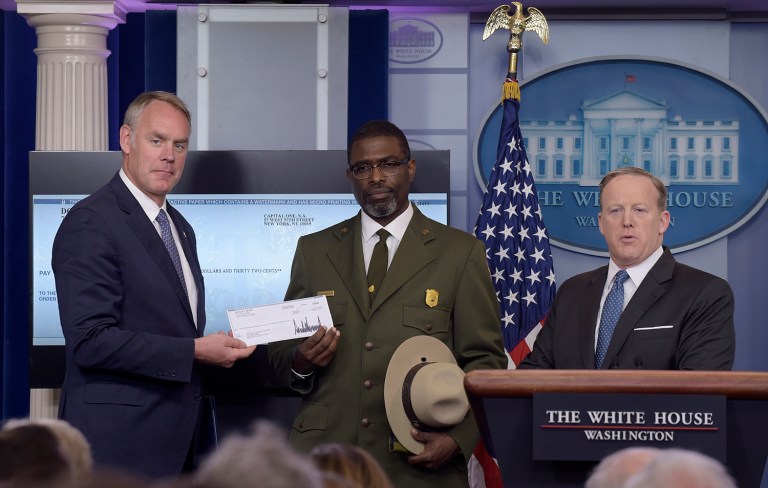 President Donald Trump gave his first quarter salary to the National Park Service. Interior Secretary Ryan Zinke, left, and Harpers Ferry National Historic Park Superintendent Tyrone Brandyburg, accompanied by White House press secretary Sean Spicer, hold up a check during the daily briefing. (AP Photo/Susan Walsh)