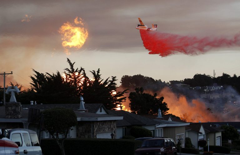 FILE - In this Sept. 9, 2010 file photo, a massive fire following a pipeline explosion roars through a mostly residential neighborhood in San Bruno, Calif. Top California regulators communicated often and enthusiastically with executives at Pacific Gas & Electric Co., even offering unsolicited advice on handling the media while they presided over a case to decide how much the utility should pay for a deadly explosion in a San Francisco Bay Area suburb, according to a trove of emails released Monday, July 28, 2014. (AP Photo/Jeff Chiu, File)