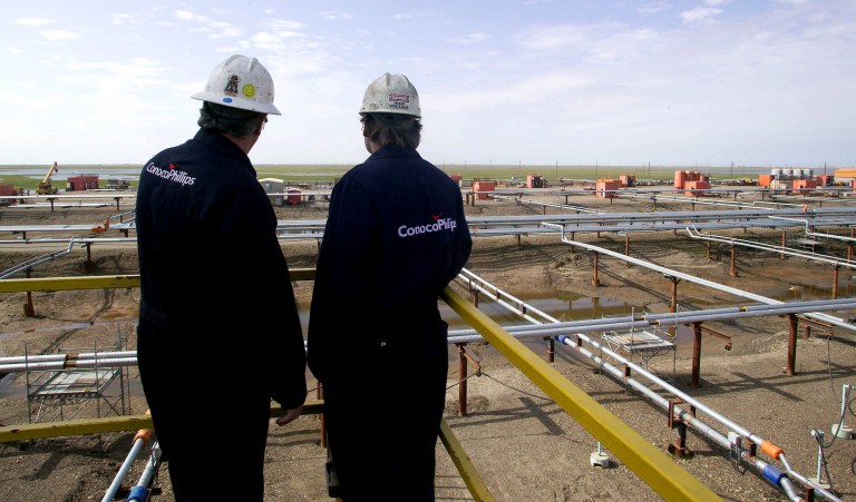 ** ADVANCE FOR WEEKEND APRIL 30-May 1 ** In this undated photo provided ConocoPhillips, two ConocoPhillips emploees overlook pipelines on the West Sak oil field on Alaska's North Slope. BP and ConocoPhillips are betting that heavy oil in Alaska will result in a big payoff. Heavy oil, which has the consistency of thick molasses instead of olive oil, lies in sandstone above the huge reservoir of North Slope light oil that has been flowing down the trans-Alaska pipeline since 1977. With that reservoir being drawn down, the Texas-based companies are turning to hard-to-pump heavy oil to extend the life of the oil fields. (AP Photo/ConocoPhillips, Judy Patrick)