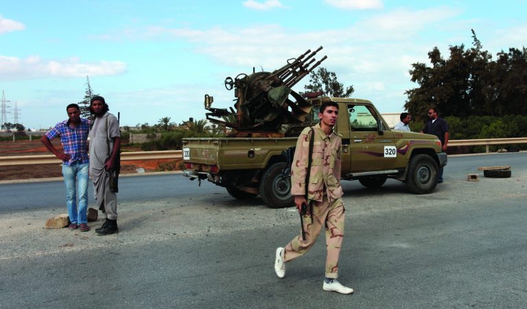 Members of the Rafallah Sahati Islamic Militia Brigades, stand on alert in front their base in Benghazi, Libya, Saturday, Sept. 22, 2012. On Friday evening, hundreds of protesters angry over last week's killing of the U.S. ambassador to Libya stormed the compound of the Islamic extremist Ansar al-Shariah Brigade militia suspected in the attack, evicting militiamen and setting fire to their building. After taking over the Ansar compound, protesters then drove to attack the Benghazi headquarters of Rafallah Sahati where militiamen opened fire on the protesters, who were largely unarmed, leaving at least 20 wounded, and several killed according to hospital sources. (AP Photo/Mohammad Hannon)