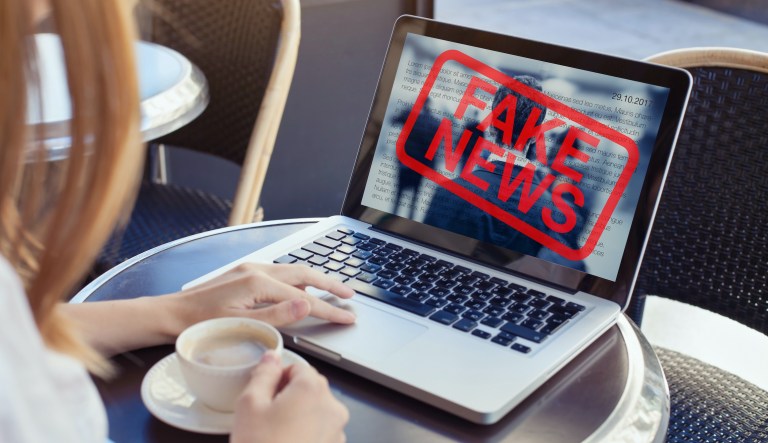 FILE - In this Tuesday, April 2, 2019, file photo, a man browses through the Twitter account of Alt News, a fact-checking website. A new survey says half of U.S. adults consider fake news a major problem, and they mostly blame politicians and activists for it.