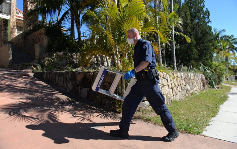 A police officer searches a house in Mount Gravatt, Brisbane, Australia, Thursday, Sept. 18, 2014. Australian police detained 15 people on Thursday in a major counterterrorism  operation, saying intelligence indicated a random, violent attack was being planned on Australian soil. (AP Photo/AAP Image, Dave Hunt)  AUSTRALIA OUT, NEW ZEALAND OUT, PAPUA NEW GUINEA OUT, SOUTH PACIFIC OUT, NO SALES, NO ARCHIVES