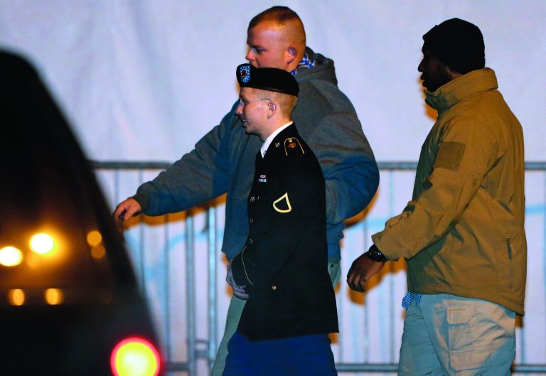Army Pfc. Bradley Manning, center, is escorted to a security vehicle outside of a courthouse in Fort Meade, Md., Tuesday, Nov. 27, 2012, after attending a pretrial hearing. Manning is charged with aiding the enemy by causing hundreds of thousands of classified documents to be published on the secret-sharing website WikiLeaks. (AP Photo/Patrick Semansky)