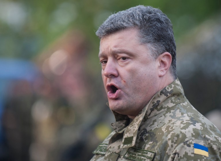 In this Tuesday, July 8, 2014 photo, Ukrainian President Petro Poroshenko addresses Ukrainian troops as he visits their base in Devhenke village, Kharkiv region, eastern Ukraine. Poroshenko will attend the World Cup final in Rio de Janeiro's Maracana stadium along with Russian President Vladimir Putin, Brazil's Foreign Ministry said Saturday, July 12, 2014. (AP Photo/Evgeniy Maloletka)