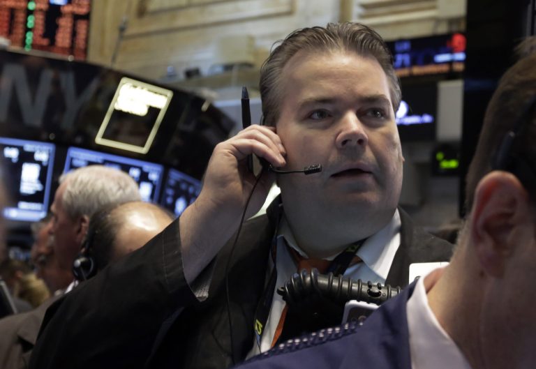 FILE - In this Wednesday, March 26, 2014, file photo, a trader works on the floor of the New York Stock Exchange. World stock markets pushed higher Wednesday April 2, 2014 on signs of a pickup in the U.S. economy and expectations of further stimulus in Japan.  (AP Photo/Richard Drew, File)