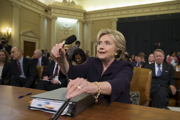 Democratic presidential candidate and former Secretary of State Hillary Rodham Clinton, returns to her seat after a break in testimony on Capitol Hill in Washington, Thursday, Oct. 22, 2015, before the House Select Committee on Benghazi. (AP Photo/Carolyn Kaster)