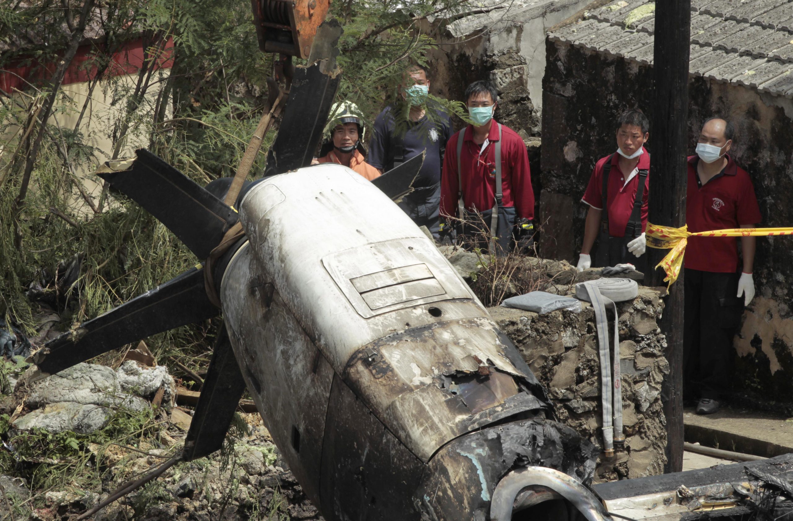 Taiwan plane survivor crawls out, phones dad