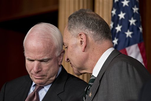 Sen. John McCain, R-Ariz., left, and Sen. Charles Schumer, D-N.Y., right, confer as they and other leading senators announce that they have reached agreement on the principles of sweeping legislation to rewrite the nation's immigration laws, during a news conference at the Capitol in Washington, Monday, Jan. 28, 2013. The deal covers border security, guest workers and employer verification, as well as a path to citizenship for the 11 million illegal immigrants already in this country.  (AP Photo/J. Scott Applewhite)