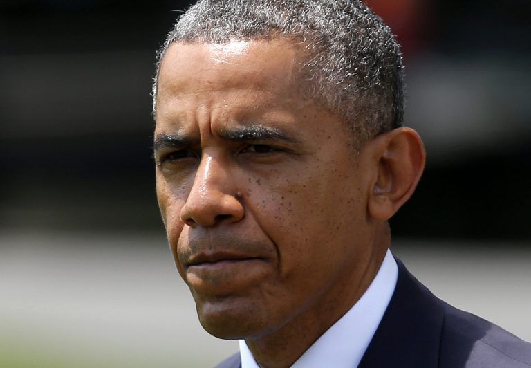 President Barack Obama finishes his statement about his administration's response to a growing insurgency foothold in Iraq, Friday, June 13, 2014, on the South Lawn of the White House in Washington, prior to boarding the Marine One Helicopter for Andrews Air Force Base, Md., then onto North Dakota and California. (AP Photo/Charles Dharapak)