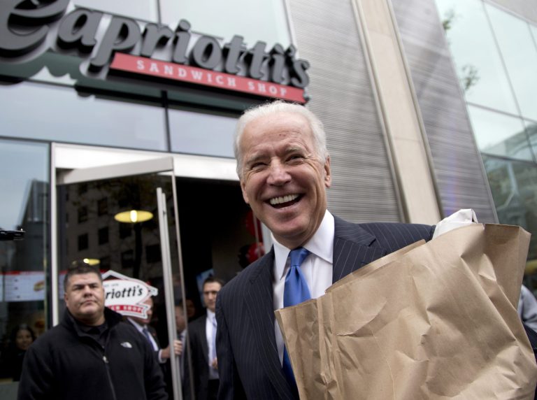 FILE - In this Nov. 21, 2013, file photo, Vice President Joe Biden carries a bag full of food as he talks with reporters outside Capriotti's Sandwich Shop in Washington. Biden has sought to make himself as central as possible to the White HouseÃ?s orbit of influence, without overstepping his role in ways he has said were counterproductive in the Bush White House. The delicate balance has sometimes paid off _ Obama has relied on Biden at critical junctures in his presidency. At other times, itÃ?s meant being relegated to lower-profile tasks or absent at key moments. (AP Photo/Carolyn Kaster, File)