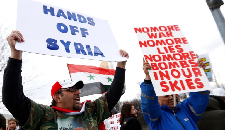 A crowd chants during a rally in opposition to U.S. missile strikes in Syria on April 7 in Allentown, Pa. Allentown has one of the nation's largest Syrian populations. They are mostly Christian and support Syrian President Bashar al-Assad. (AP Photo/Julio Cortez)