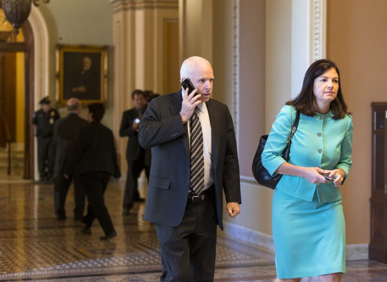   Sen. John McCain, R-Ariz., left, and Sen. Kelly Ayotte, R-N.H. walk to their party caucuses on Capitol Hill in Washington, Tuesday, Sept. 24, 2013, as the Senate struggles with a stopgap spending bill that would prevent a partial government shutdown when the budget year ends next week. Tea party-leaning members of the House GOP caucus successfully attached language to that bill last week that would strip funding for President Barack Obama's health care program. (AP Photo/J. Scott Applewhite)  