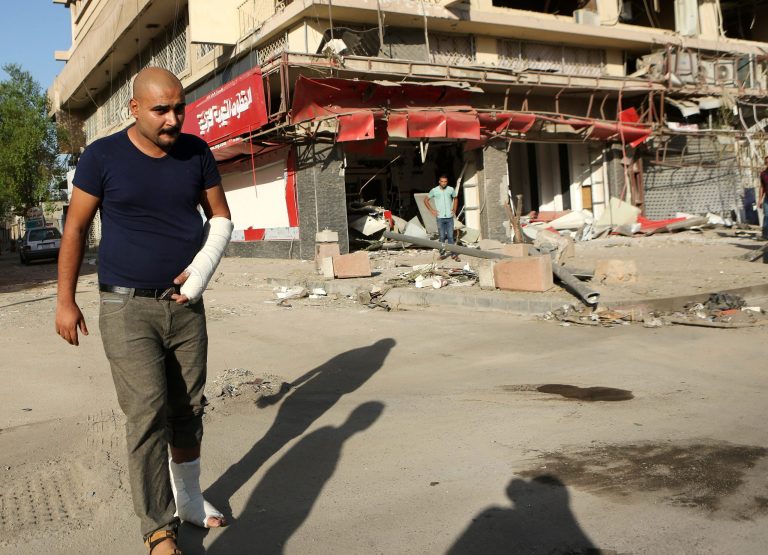 Civilians gather at the site of a car bomb attack on Saadoun street in Baghdad, Iraq, Friday, Sept. 5, 2014. The bomb exploded in a commercial area in central Baghdad on Tuesday night, killing and wounding civilians, officials said. (AP Photo/Hadi Mizban)