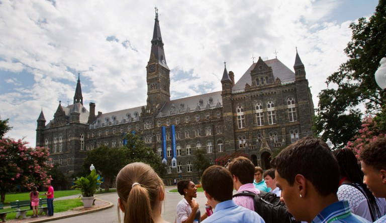 In this July 10, 2013, file photo, prospective students tour Georgetown University's campus in Washington. Georgetown University will give preference in admissions to the descendants of slaves owned by the Maryland Jesuits as part of its effort to atone for profiting from the sale of enslaved people, the president of the prominent Jesuit university in Washington announced Thursday, Sept. 1, 2016. 