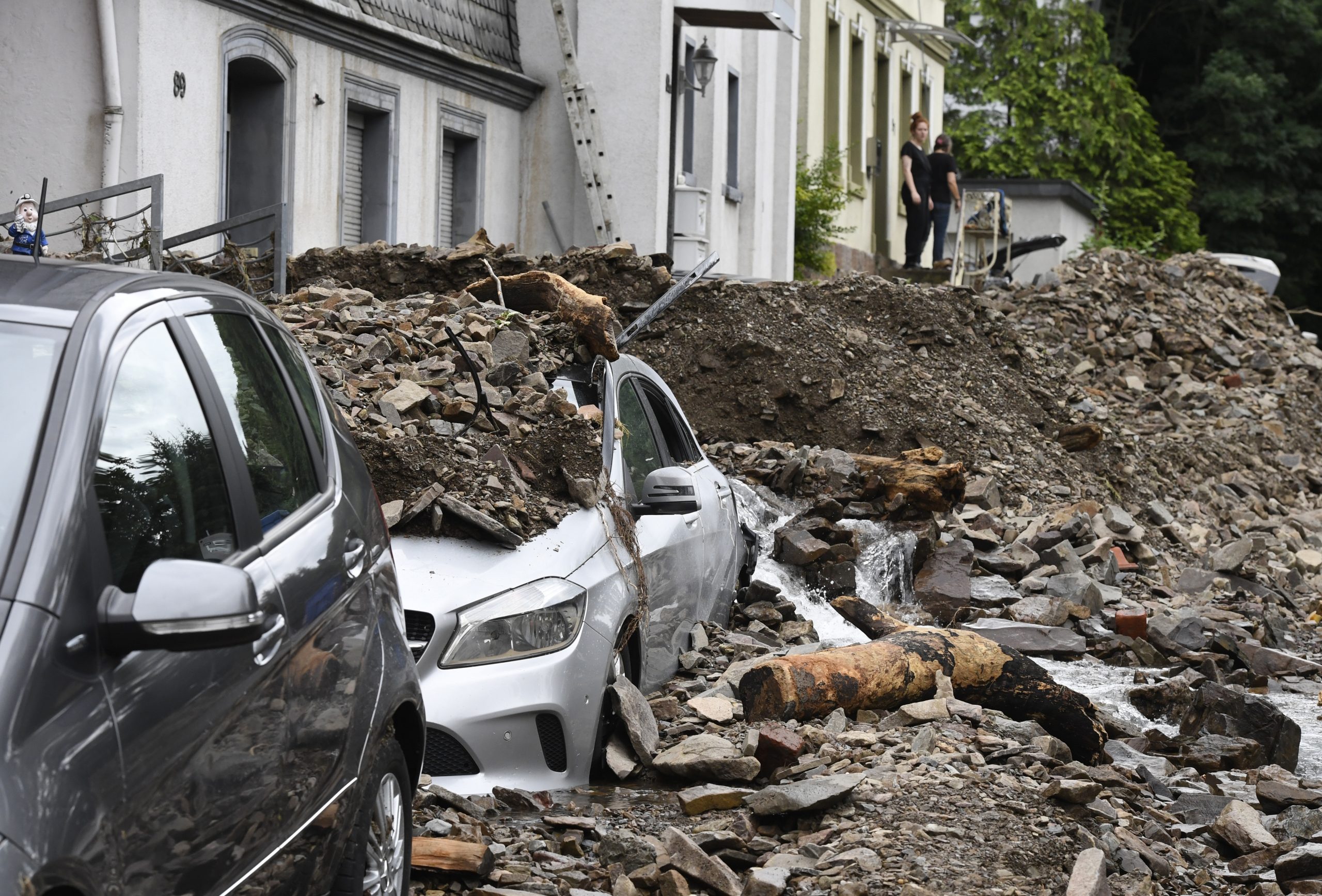 Residents look at the damage caused by the flooding