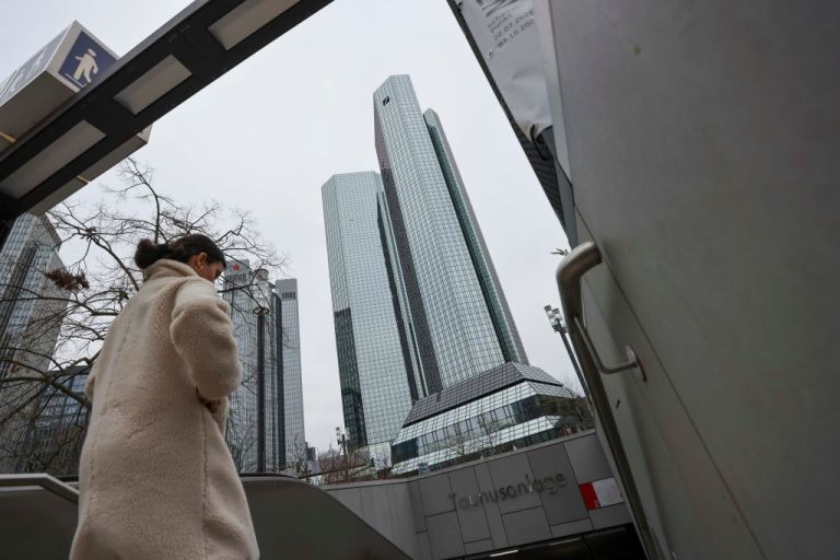 A pedestrian enters a subway near the headquarters of Deutsche Bank AG in the financial district of Frankfurt, Germany, on Monday, Jan. 24, 2022. 
