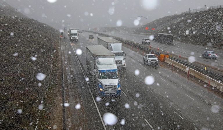 TEJON PASS, CA - FEBRUARY 23: Snow flurries fall while tractor trailers and automobiles travel along Interstate 5 at the Tejon Pass along the Grapevine on Thursday, Feb. 23, 2023 in Tejon Pass, CA.