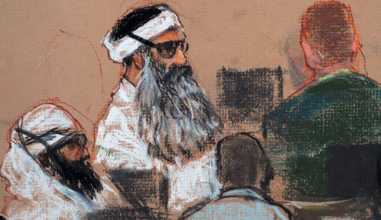 A courtoom drawing by artist Janet Hamlin, reviewed by the U.S. military, shows Khalid Sheikh Mohammed,center, and co-defendant Walid Bin Attash,left,  attending a pre-trial session Monday,Dec.  8, 2008, at the Guantanamo Bay Naval Base, Cuba .   Mohammed is the alleged mastermind of the Sept. 11, 2001, attacks.