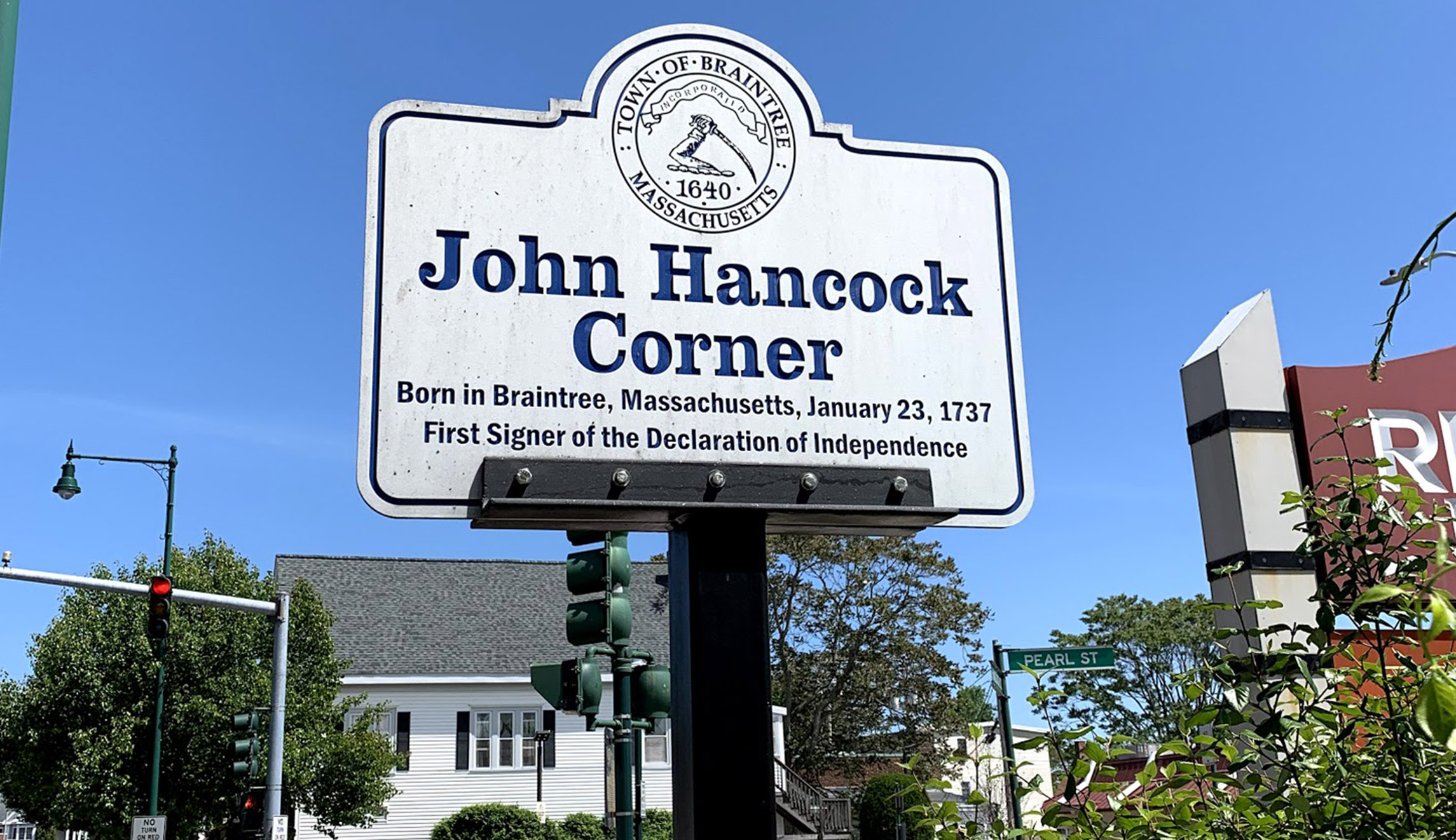 A sign indicating John Hancock Corner is seen in Braintree, Massachusetts.