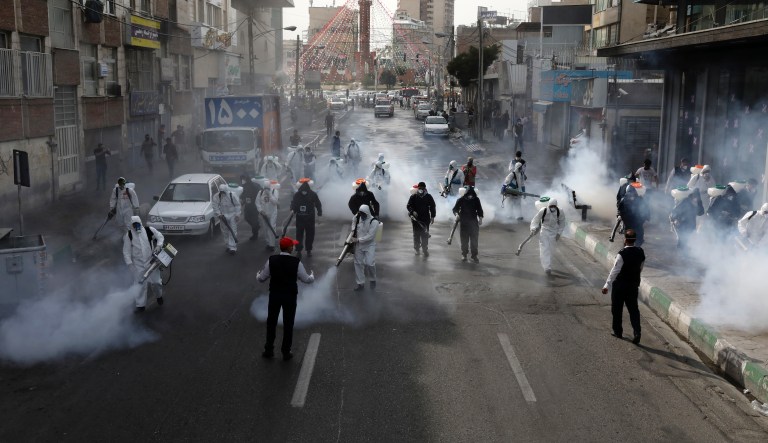 Firefighters disinfect a street against the new coronavirus, in western Tehran, Iran, Friday, March 13, 2020. The new coronavirus outbreak has reached Iran's top officials, with its senior vice president, Cabinet ministers, members of parliament, Revolutionary Guard members and Health Ministry officials among those infected.  The vast majority of people recover from the new coronavirus. According to the World Health Organization, most people recover in about two to six weeks, depending on the severity of the illness.