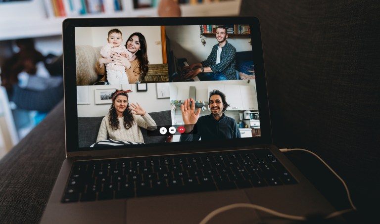 Young woman using a laptop to connect with her friends and parents during quarantine. 