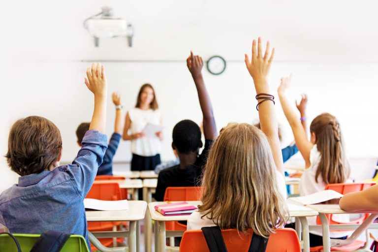 A teacher looks at students in a classroom.