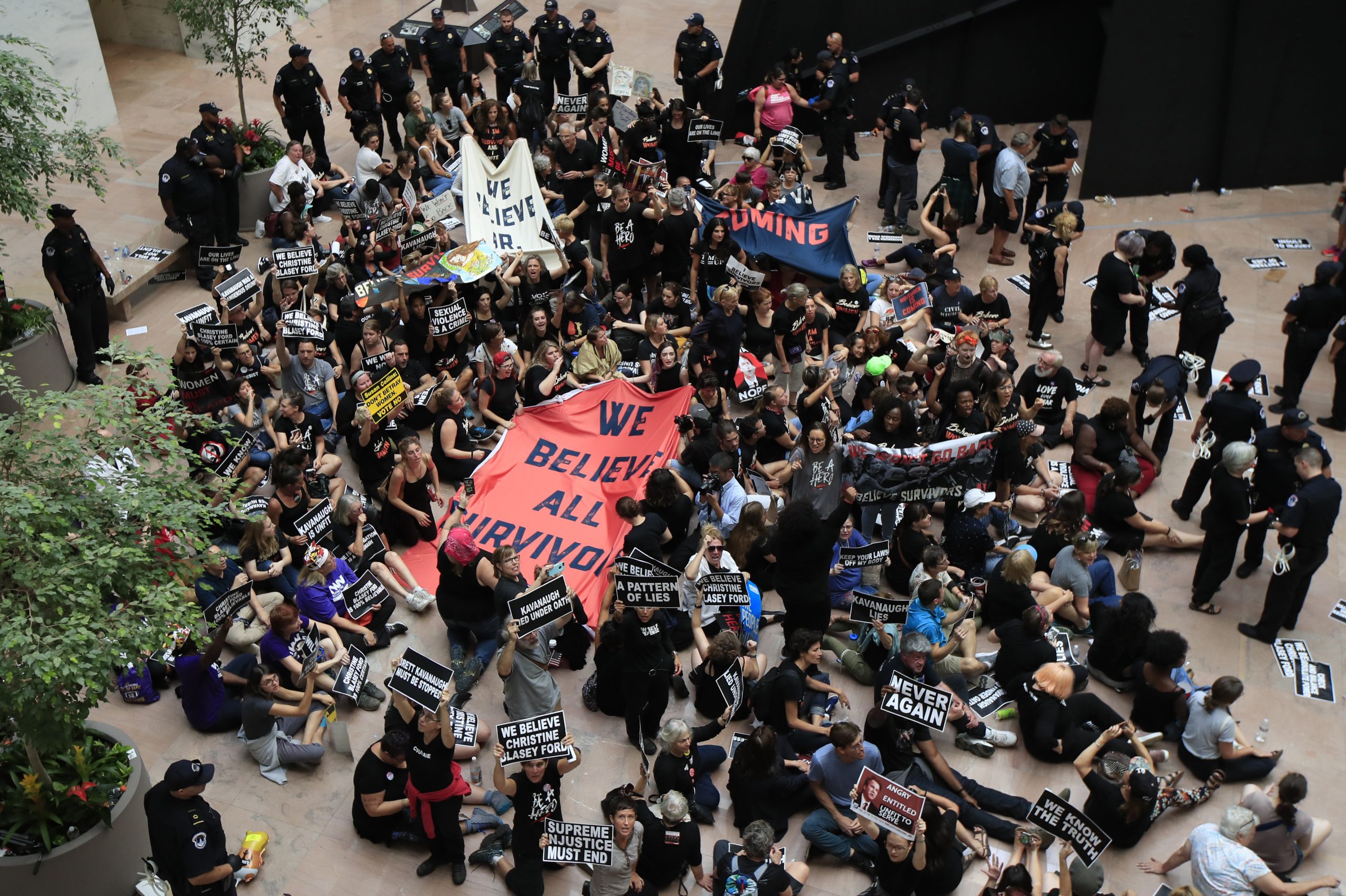 Protesters against Supreme Court nominee Brett Kavanaugh sit in the atrium of the Hart Senate Office Building on Capitol Hill in Washington on Thursday.