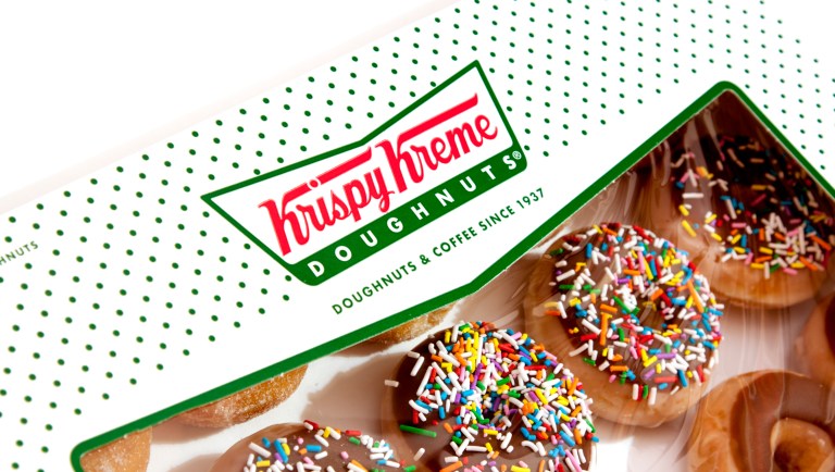 Jayson Gonzalez reaches into his car for another box of Krispy Kreme doughnuts for customers in Little Canada, Minn. who ordered online Saturday, Oct. 26, 2019. Gonzalez, a 21-year-old college student, drives an eight-hour round trip to Iowa to pick up the doughnuts not available in Minnesota. He's paying off his college debt with the profits.