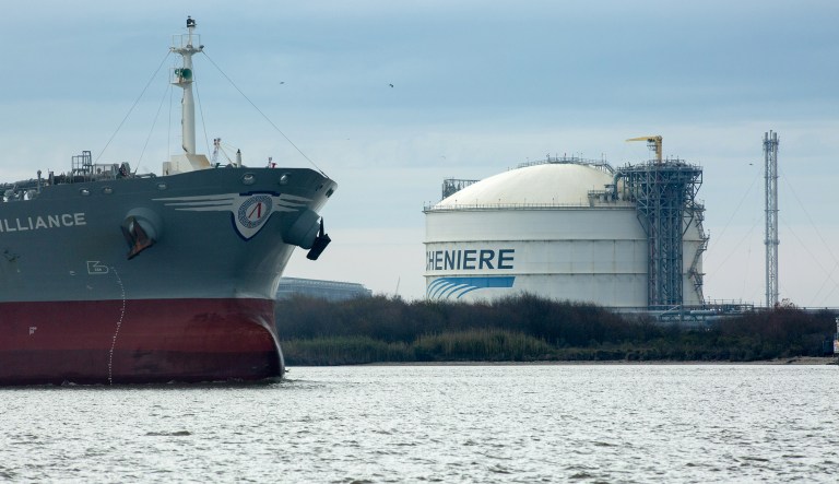 The Amazon Brilliance oil tanker sails past a storage tank at the Cheniere Energy Inc. liquefied natural gas (LNG) terminal in Sabine Pass, Louisiana, U.S., on Thursday, Jan. 14, 2016. Cheniere Energy Inc. said its first cargo of LNG from its new Louisiana export terminal will be delayed by as much as two months because of faulty wiring.
