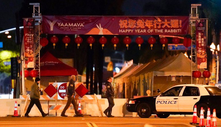 FBI agents walk near a scene where a shooting took place in Monterey Park, Calif., Sunday, Jan. 22, 2023. Ten people were killed in a mass shooting late Saturday in a city east of Los Angeles following a Lunar New Year celebration that attracted thousands, police said. (AP Photo/Jae C. Hong)