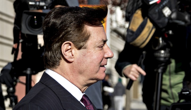 Paul Manafort walks out of a federal courthouse.