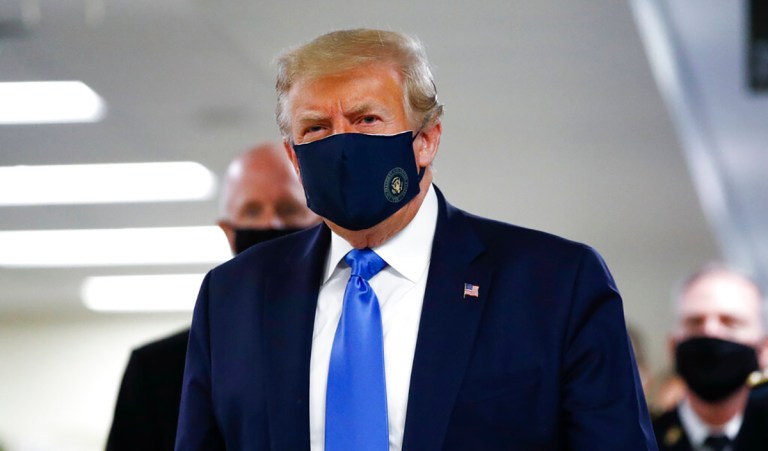 A student wears a mask as they march to the Chinese University to show support to those students who were arrested by police in Hong Kong, Thursday, Oct.3, 2019. 