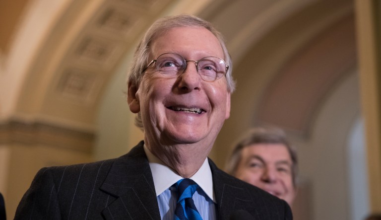 Senate Majority Leader Mitch McConnell, R-Ky., smiles as he meets with reporters as work continues on a plan to keep the government as a funding deadline approaches, at the Capitol in Washington, Tuesday, Feb. 6, 2018.